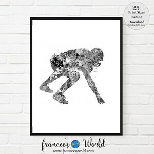 May include: Black and white watercolor painting of a football player in a running pose. The player is depicted in a dynamic, action-filled stance, with splashes of color adding a vibrant touch to the artwork.