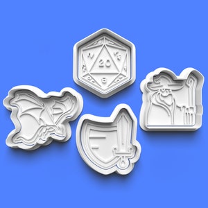 May include: Four white plastic cookie cutters shaped like a dragon, a sword and shield, a wizard, and a 20-sided die.