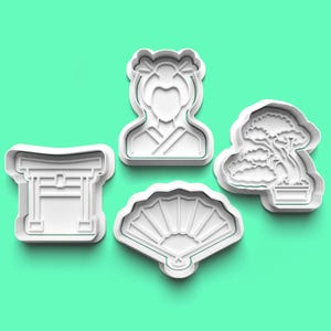 May include: Set of five white plastic cookie cutters shaped like Japanese cultural icons: a geisha, a fan, a torii gate, and two bonsai trees.