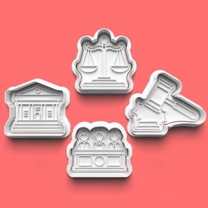May include: Four white plastic cookie cutters shaped like legal symbols: a courthouse, a gavel, scales of justice, and a judge's bench with three figures.