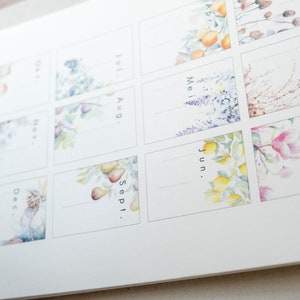 May include: A watercolour calendar with floral illustrations for each month. The months are labelled: January, February, March, April, June, May, July, August, September, and December.