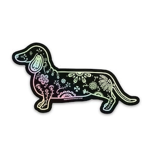 May include: A black and white sticker of a dachshund with a floral pattern. The sticker has a holographic finish that shimmers in rainbow colors.
