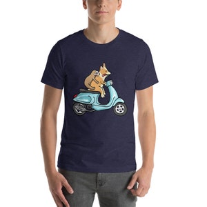 May include: A navy blue t-shirt with a cartoon illustration of a corgi and a sloth riding a blue scooter.
