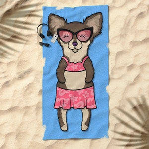 May include: A cartoon chihuahua wearing pink sunglasses and a pink bikini is lying on a blue beach towel. The chihuahua is smiling and has its eyes closed. The towel is on a sandy beach.