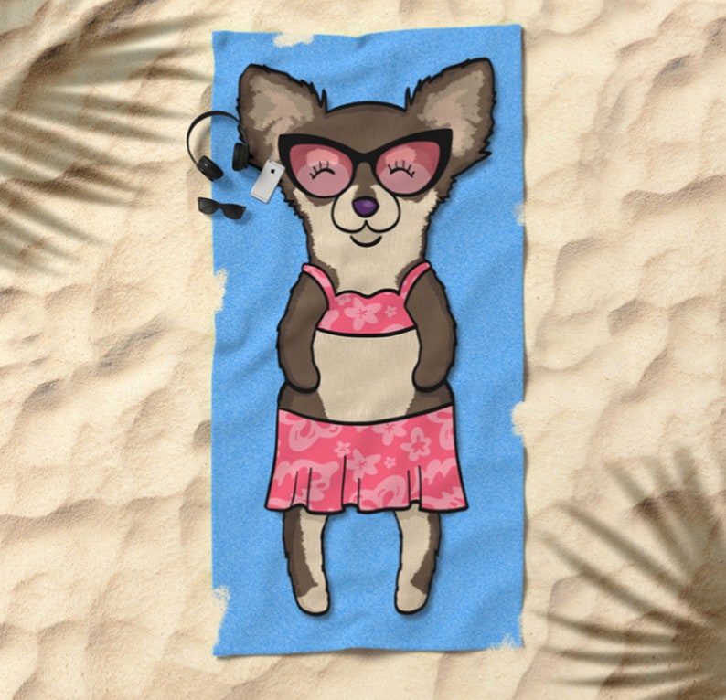 May include: A cartoon chihuahua wearing pink sunglasses and a pink bikini is lying on a blue beach towel. The chihuahua is smiling and has its eyes closed. The towel is on a sandy beach.