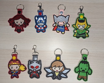 May include: Set of 10 embroidered keychains featuring various Marvel characters, including Captain America, Thor, Loki, Hulk, Scarlet Witch, Ant-Man, and Wasp. Each keychain is approximately 2 inches tall and features a colorful design with intricate details.