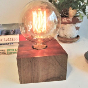 N-39 Graceful butternut table lamp with an Edison style 4" globe bulb and an in-line DIMMER switch