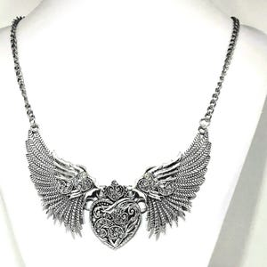 fairy wings with heart necklace, silver color.