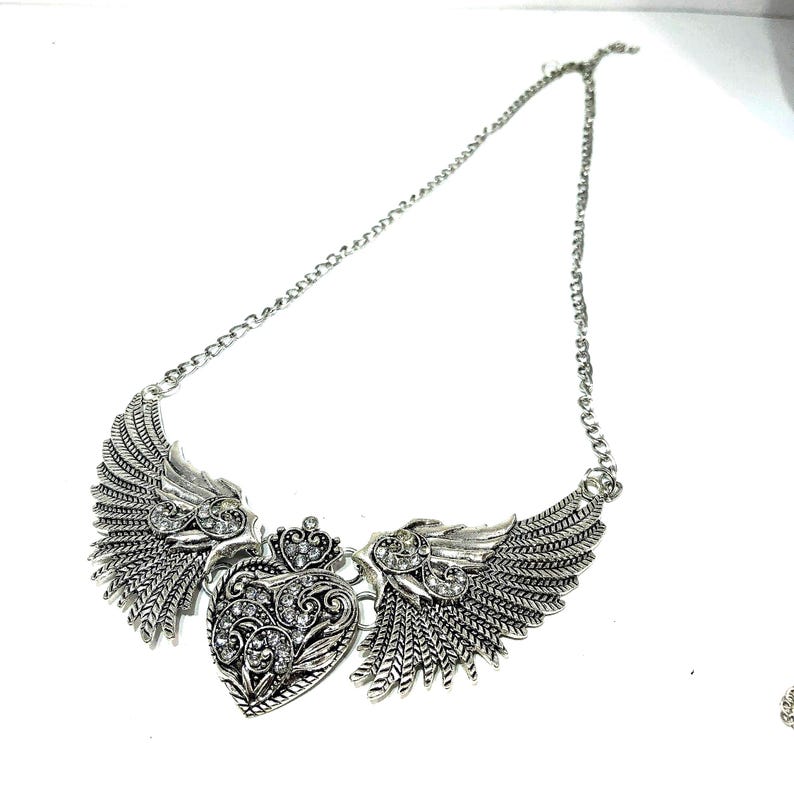 large wings with heart statement necklace, antique silver color