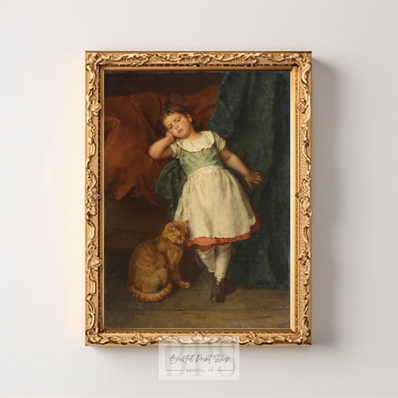 May include: A framed oil painting of a young girl in a white dress with a red sash, leaning against a red cushion. She is looking to the side with a thoughtful expression. A ginger cat sits beside her. The painting is set against a dark green background.