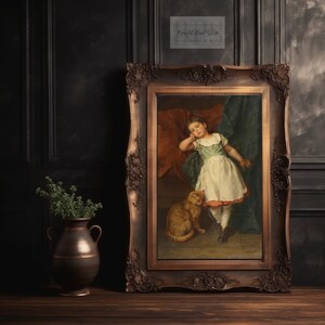 May include: A framed oil painting of a young girl in a white dress and a green bodice, sleeping with her head resting on a red pillow. A ginger cat sits beside her. The painting is in a dark brown ornate frame.
