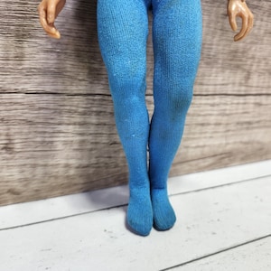 May include: A pair of blue tights with a ribbed texture.