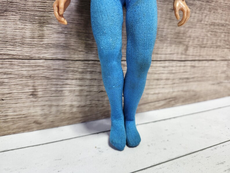 May include: A pair of blue tights with a ribbed texture.