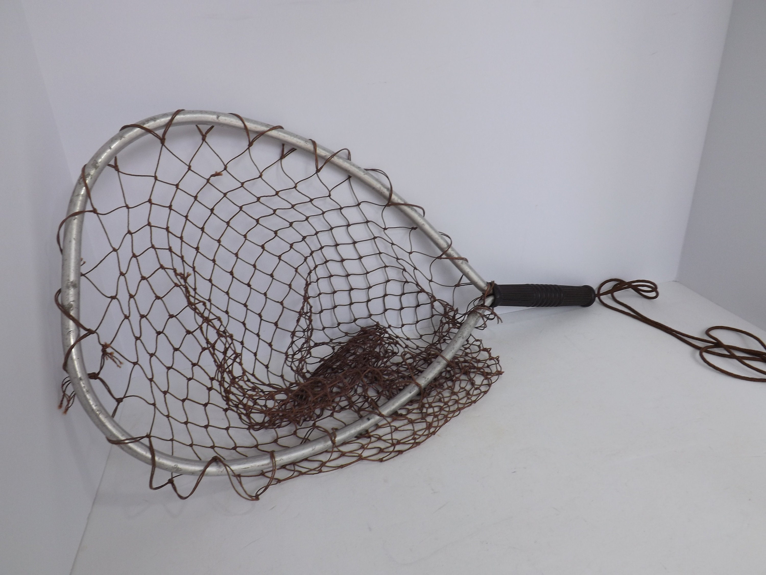 Antique fishing lures displayed on vintage net  Fishing cabin decor,  Fishing bedroom, Fishing room