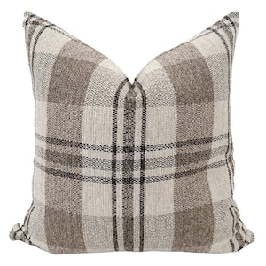 May include: A brown and white plaid throw pillow with a subtle black plaid pattern.