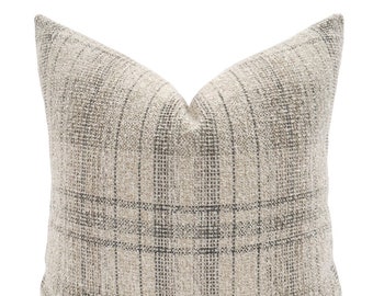 May include: A beige and gray plaid throw pillow with a subtle textured weave.