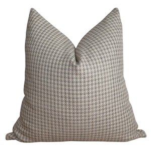 May include: A gray and white gingham patterned throw pillow. The pillow is made of a soft, woven fabric.