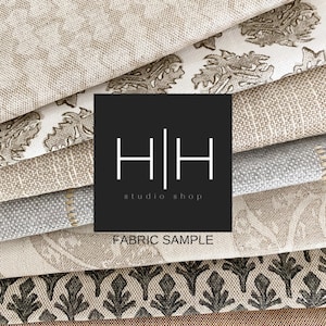 May include: A stack of fabric samples in various patterns and colors, including beige, brown, gray, and black. The fabric samples are arranged in a staggered pattern. A black square with the text "H|H studio shop" and "FABRIC SAMPLE" is in the center of the image.
