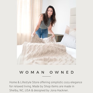 May include: A woman is making a bed with a beige knitted throw blanket. The text "HACKNER HOME Studio Shop WOMAN OWNED Home & Lifestyle Store offering simplistic cozy elegance for relaxed living. Made by Shop items are made in Shelby, NC, USA & designed by Jona Hackner. Follow & be inspired JPf HACKNERHOME.COM" is visible in the image.