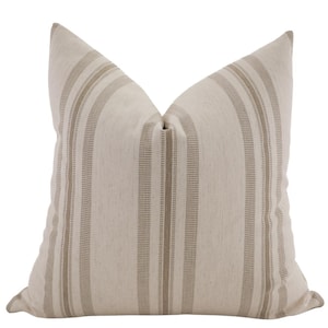 May include: A beige and brown striped throw pillow with a square shape.