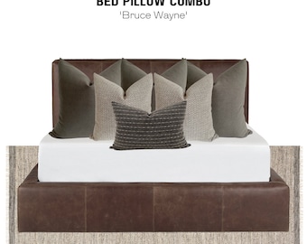 May include: A brown leather bed with a white mattress and a variety of pillows in shades of gray and beige. The pillows are arranged in a symmetrical pattern, with the largest pillow in the center. The bed is sitting on a light gray rug.