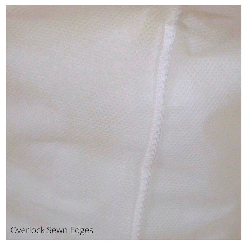 May include: Close-up of a white fabric with an overlock stitch along the edge. The fabric has a textured surface. "Overlock Sewn Edges" is written in black text at the bottom of the image.