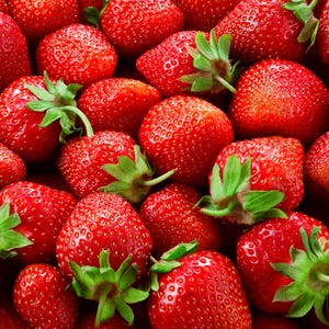 May include: A collection of fresh, ripe strawberries with vibrant red skin and small yellow seeds. Each strawberry features a bright green leafy calyx at the top, creating a dense, textured pattern of fruit filling the entire frame.