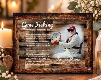 May include: A rectangular memorial plaque with a rustic wood-grain frame. It features the text Gone Fishing, a poem, a photograph of a person holding a fish, and the name James Davis with the dates March 3, 1978 - May 3, 2023.