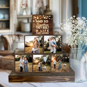 May include: A set of six wooden blocks with photos of a family in a field. The top block has a quote that reads "And so together they built a life they loved".
