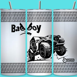 May include: A white tumbler with a black off-road vehicle graphic and the words "Bad Boy". The design includes tire track patterns and the word "Haters" with a hand gesture.