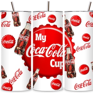 May include: White tumbler with a red Coca-Cola bottle cap design. The cap has the words "My Coca-Cola Cup" in white lettering. The tumbler is decorated with a pattern of Coca-Cola bottles and logos.
