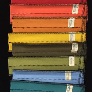 May include: A stack of 14 colorful fabric strips with the text "Drinking Straws" printed on each strip. The strips are in various colors, including gray, black, red, orange, yellow, green, blue, teal, brown, and pink.
