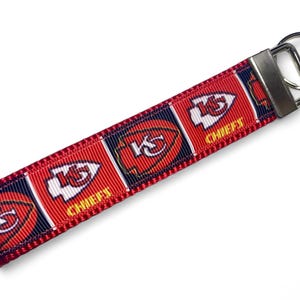 May include: Red, white, and blue key chain with the Kansas City Chiefs logo and "Chiefs" text.