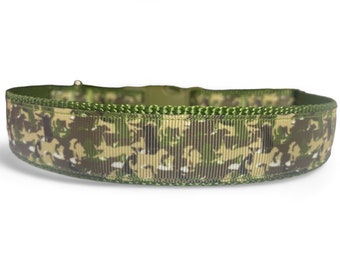 May include: A green, brown, and white camouflage patterned dog collar with a green edge.