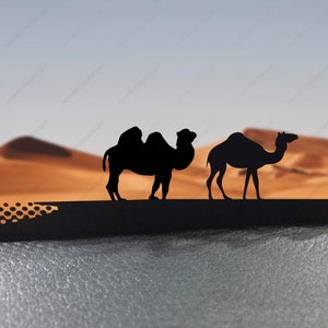 May include: Silhouettes of two camels against a desert background. The camels are facing the same direction, with the camel in the foreground slightly larger than the camel in the background.