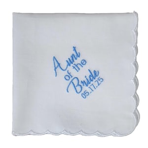 May include: White handkerchief with scalloped edges and blue embroidery that reads "Aunt of the Bride 05.17.25".