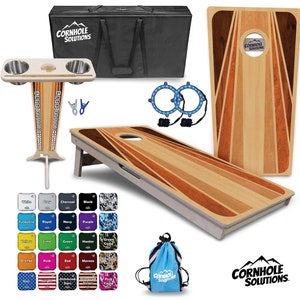 May include: A set of two wooden cornhole boards with a striped design, a black carrying case, two cup holders, two bean bags, and a blue drawstring bag with the text "Cornhole Solutions".