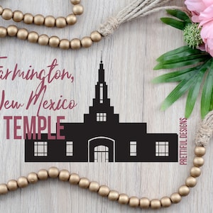 May include: Black silhouette of the Farmington, New Mexico Temple with the text "Farmington, New Mexico TEMPLE" in pink script. The image is surrounded by a wooden background with a gold beaded garland and a brown tassel.