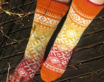 May include: A pair of orange and white patterned socks with a geometric design. The socks are made of a soft, knitted fabric.