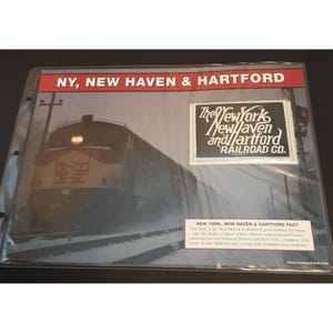May include: A black and white photo of a train with the text "The New York New Haven and Hartford Railroad Co." on a white patch. The text "NY, NEW HAVEN & HARTFORD" is at the top of the image.