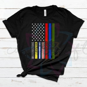 May include: Black t-shirt with a thin blue line American flag design. The flag has the words "Corrections", "Dispatch", "Nurse", "Firefighter", "Police", and "Military" written vertically on the stripes.