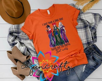 May include: Orange t-shirt with a graphic of three witches and the text "I just took a DNA test. Turns out I'm 100% that witch."