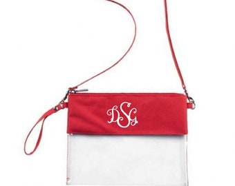 Puede incluir: Bolso bandolera de plástico rojo y transparente con un monograma blanco "DSG" en la solapa roja.