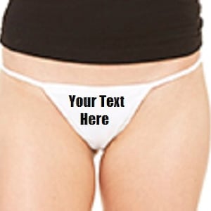 May include: White string bikini with the text "Your Text Here" printed on the front.