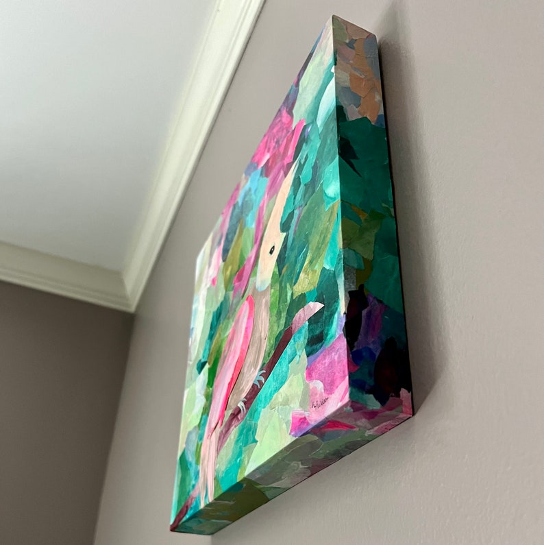 May include: A pink and green painting of a bird in a leafy setting. The painting is on a canvas and has a textured surface.