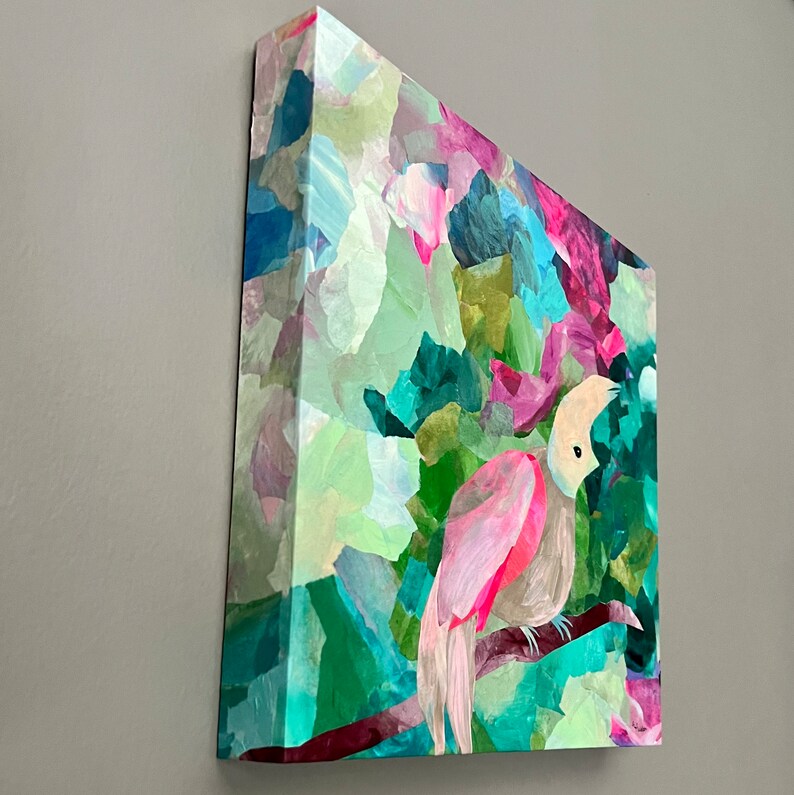 May include: Abstract painting of a pink bird with a white head perched on a branch in a colorful, leafy forest. The painting is done in a collage style with different shades of green, blue, pink, and purple.