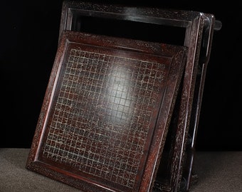 May include: A dark brown wooden folding game board with a grid pattern. The board is closed and folded in half, with the top half slightly open.