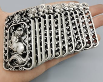 May include: A stack of silver-coloured pendants with intricate designs. Each pendant features a rat, the Chinese zodiac animal for the year 2020, and the Chinese character for "rat".