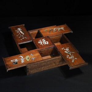 May include: A multi-compartment wooden box with hinged lids, each adorned with inlaid floral, bird, and bamboo designs. The central lid features the inlaid Chinese character "福". The box is crafted from dark wood.