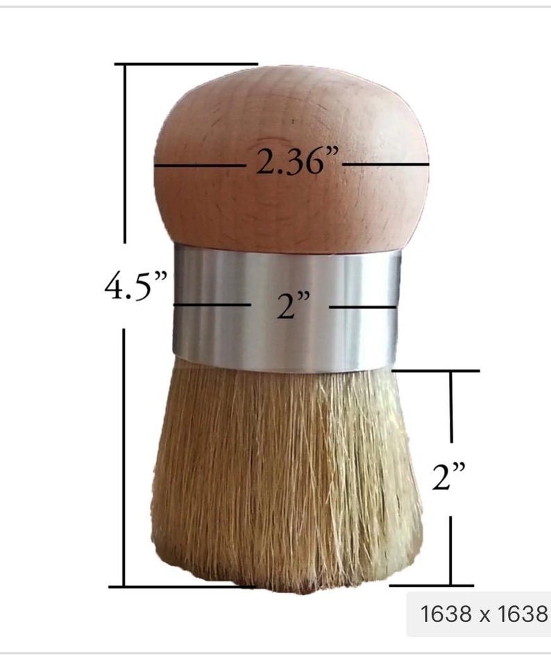 May include: A round wooden handled brush with a silver metal band and light tan bristles. The brush has a total height of 4.5 inches, a handle diameter of 2.36 inches, a metal band width of 2 inches, and a bristle length of 2 inches.